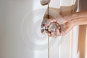 Woman hand holding a doorknob