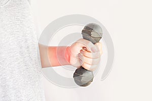 Woman hand holding dumbbell suffering from wrist and arm pain