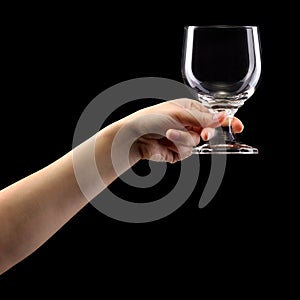 Woman hand holding empty beer glass isolated on black.