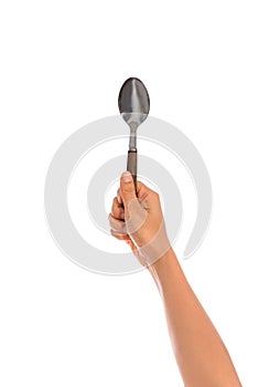 Woman hand holding an empty spoon, composition isolated on white