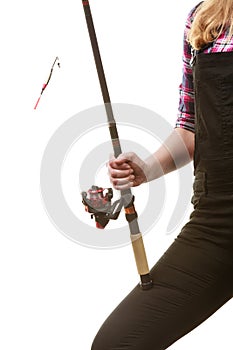 Woman hand holding fishing rod, spinning equipment