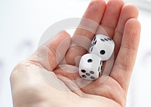 Woman hand holding five dice. Playing cube with numbers. Items for board games.