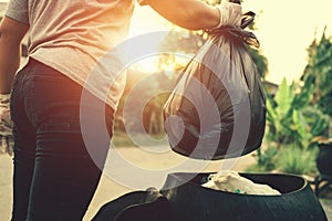 woman hand holding garbage bag for recycle