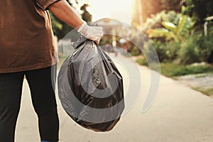 woman hand holding garbage bag for recycle putting in to trash