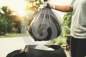 woman hand holding garbage bag for recycle photo