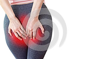 Woman hand holding her painful butt caused by hemorrhoids