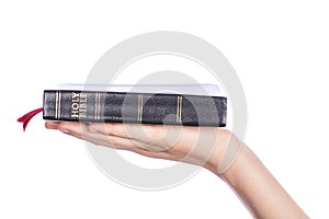 Woman hand holding the Holy Bible on white background