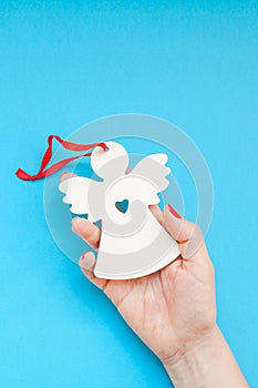 Woman hand holding homemade wooden christmas toy