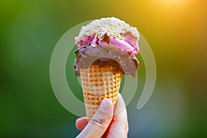 Woman hand holding ice cream cone in summer