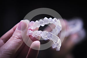 Woman hand holding invisible orthodontics