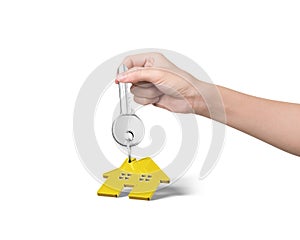 Woman hand holding key with house shape keyring