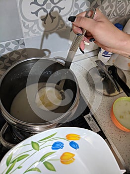 Woman hand holding a ladle