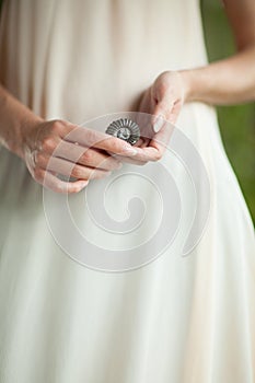 Woman hand holding little fossile ammonite, sensual studio shot with soft light