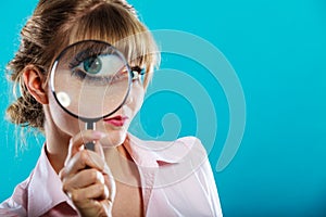 Woman hand holding magnifying glass on eye