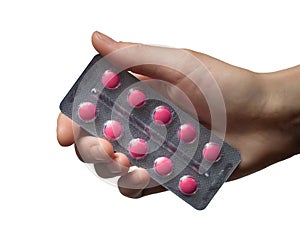 Woman Hand holding medical drugs - full silver leaflet of red pills in common tablets shape, isolated on white.