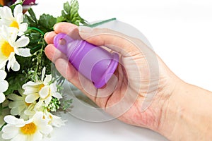 Woman hand holding a menstrual cup