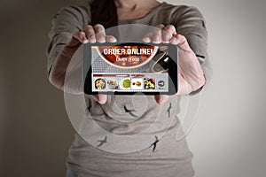 Woman hand holding mobile with order food online.