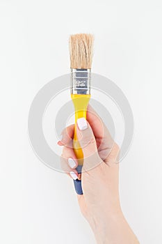 Woman hand holding new paint brush