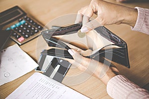 Woman hand holding one coin bankrupt broke after credit card payday