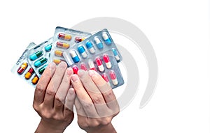 Woman hand holding pack of antibiotic capsule pills isolated on white background. Giving or receiving drug. Antibiotic drug