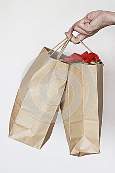 Woman hand holding packet with gift boxes