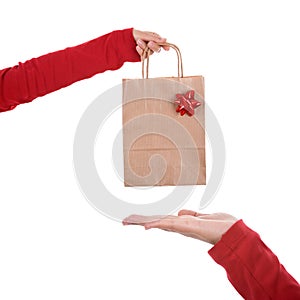 Woman hand holding papper bag with red ribbon