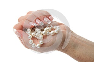 Woman hand holding pearl jewelery