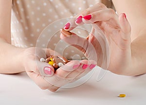 Woman hand holding pills.