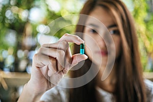 Woman hand holding a pills take medicine according to the doctor`s