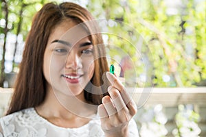 Woman hand holding a pills take medicine according to the doctor`s