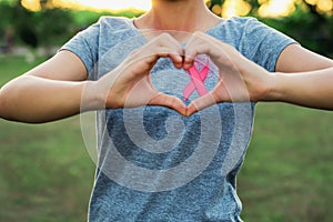 woman hand holding pink ribbon breast cancer awareness