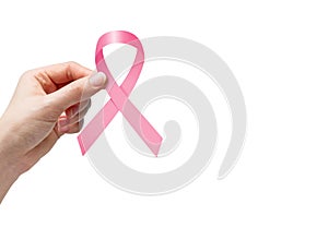 Woman hand holding pink ribbon for breast cancer awareness