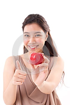 Woman with hand holding red apple, giving thumb up