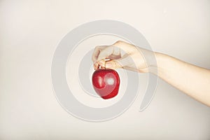 Woman hand holding red apple photo