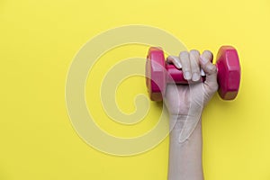 Woman hand holding red dumbbell