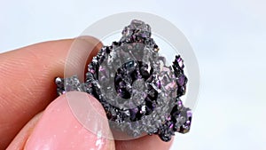 Woman hand holding shiny black Carborundum crystal (Moissanite or Silicon Carbide)