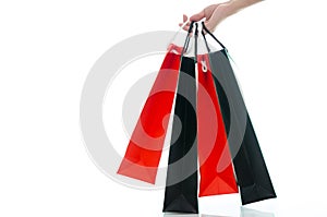 Woman hand holding shopping bag on white background