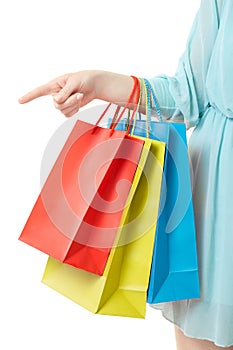 Woman hand holding shopping bags, pointing at