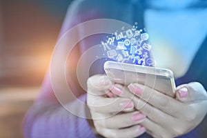 Woman hand holding smart phone connecting to internet and social media icons