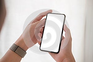 Woman hand holding smartphone with blank white screen