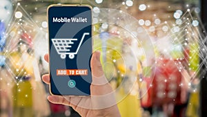Woman hand holding smartphone with blurred shop background, with mobile wallet electronic and shopping online concept,with Qr code