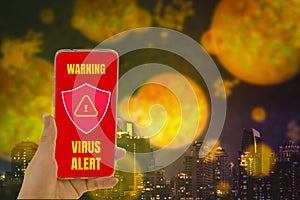 Woman hand holding smartphone in hand,with red screen and shield icon virus corona alert security,with virus background concept