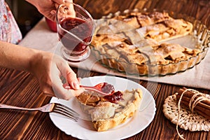 Woman hand holding a spoon with a jam. Eating sweet food context. Traditional holidays apple pie. Relishing sweet treats