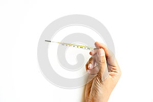Woman hand holding thermometer on white background, Top view, copy space. Medicine concept