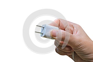 Woman hand holding white adapter plug for smart phone.