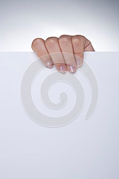 Woman hand holding white blank paper