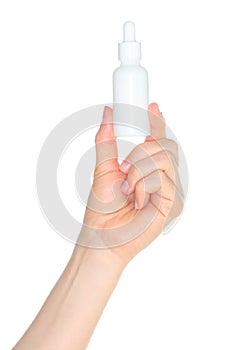 Woman hand holding a white cosmetic bottle, isolated on transparent background close-up, template for cosmetics ads