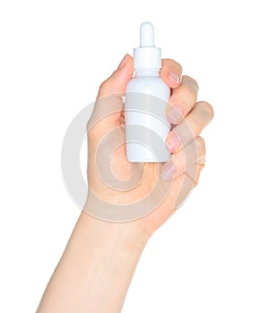 Woman hand holding a white cosmetic bottle, isolated on transparent background close-up, template for cosmetics ads