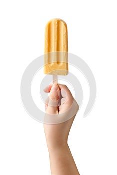 Woman hand holding yellow fruit popsicle on white background