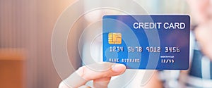 Woman hand holds a blue credit card